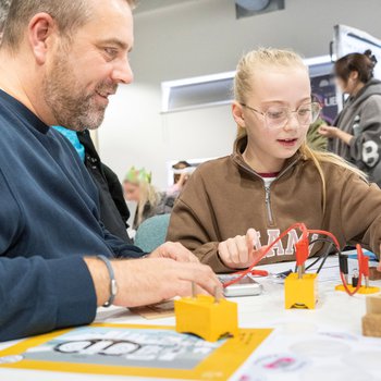 Dad and daughter doing science experiment