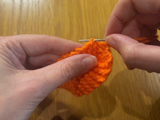 Sewing a yarn tail into a piece of knitting