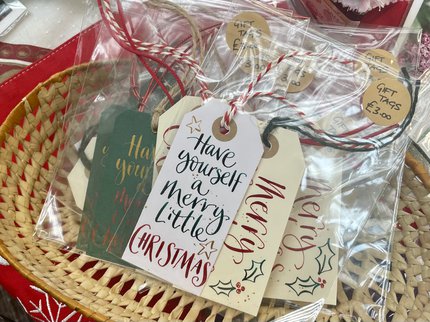 Red, green and white Christmas gift tags with cursive writing