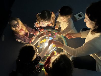 Girls around a dome exploring light and blocks