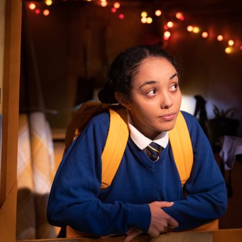 Schoolgirl Abi (Jazmine Wilkinson) looks out wistfully from the Dutch door of a brightly coloured shed.