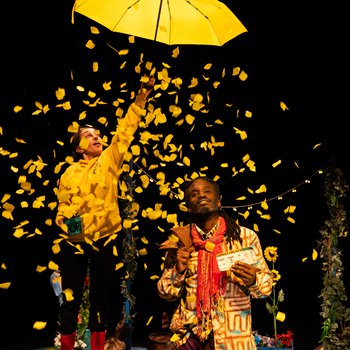 Abi (Jazmine Wilkinson) opens a yellow umbrella over Grandad (Marcus Hercules) showering him with yellow confetti.