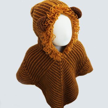 A picture of a child size mannequin wearing a hand knitted Story Snuggler with a hood