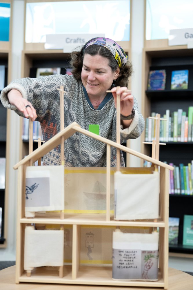 Photo of Storyteller Beccy Dye operating the crankie theatre