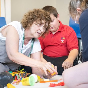 Photo of Storyteller Nicky Rafferty, working with children from Bracken Hill School