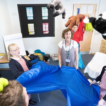 Photo of Storyteller Nicky Rafferty, working with children from Bracken Hill School
