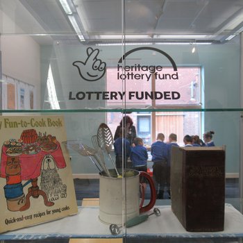 Photo of exhibition space with Heritage lottery fund logo about the doorway