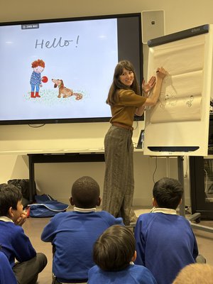An author reads her book to a child next to a table