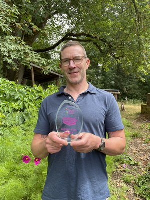 Author Phil Hickes holding his InspiRead trophy