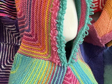 A multi coloured knitted Story Snuggler