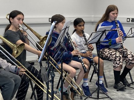 A group of children playing woodwind instruments