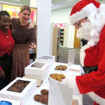 Santa browsing a stall selling cookies