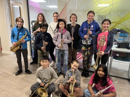 A group of children holding instruments