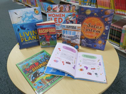 A table with various non fiction books on a round table