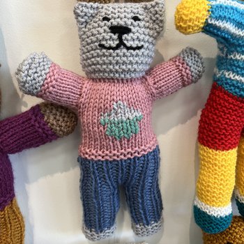 A hand knitted Brave Bear with a pink jumper
