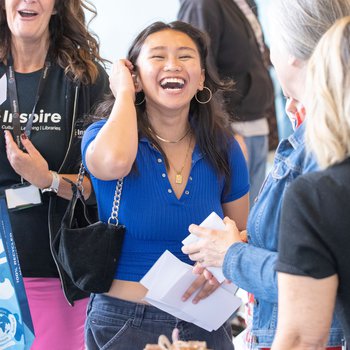 A student laughing, results in her hand.