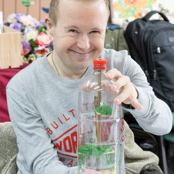 Photo of a young man holding a story bottle