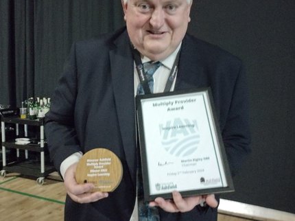 Ian Bond, Inspire Learning Director smiles as he receives the Kirkby Multiply Award at the Discovering Ashfield Awards event.