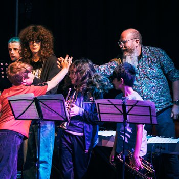 a group of musicians high fiving