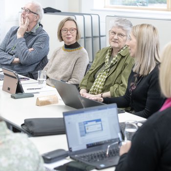 Inspire Board members attending a meeting