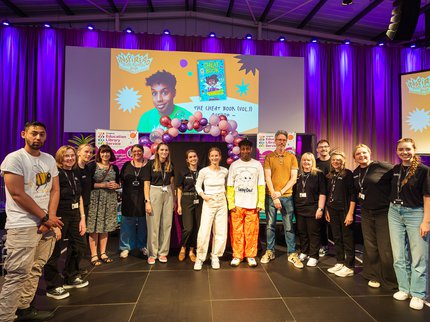A group of ELS staff and authors stood on a stage