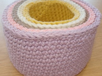 Different coloured crocheted baskets