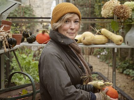 Author Kathy Slack in a greenhouse