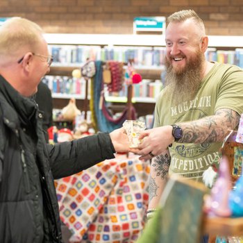 Stallholder smiling talking to a customer