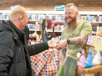 Stallholder smiling talking to a customer