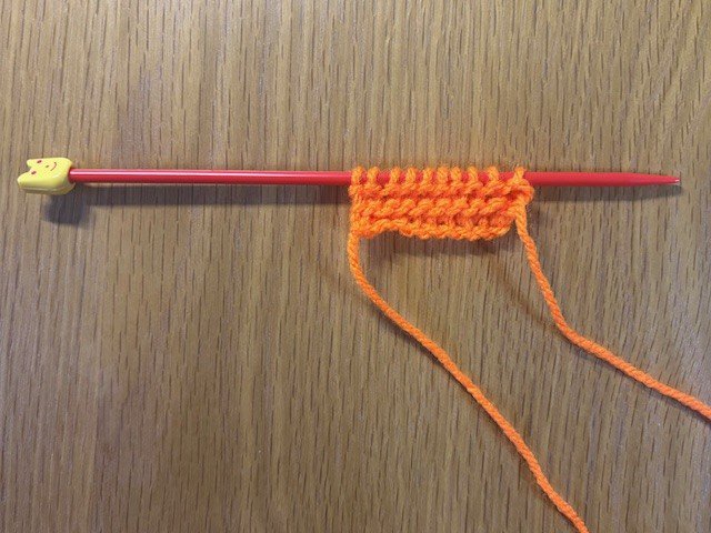 Four rows of knitting on a knitting needle