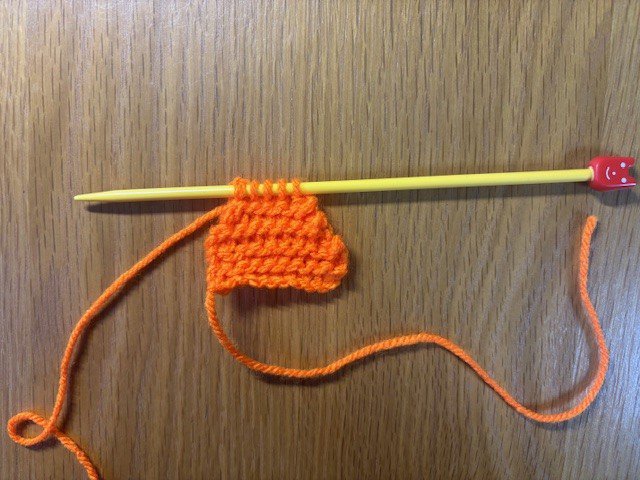 A piece of knitting showing decreasing, to make a fish tail shape