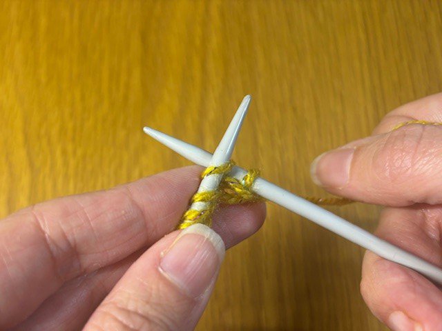 Photo of a knitting needle going into the second stitch in a row