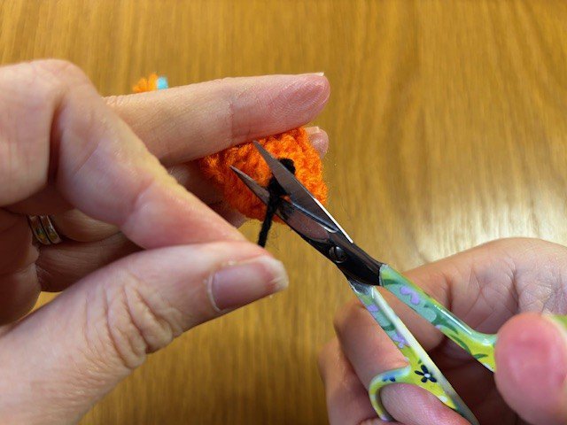 Scissors snipping off a yarn tail