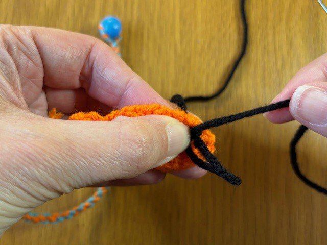 Tying a knot in a piece of yarn