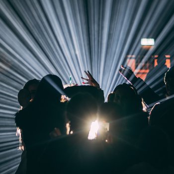 Shadows of people in front of a light projection.