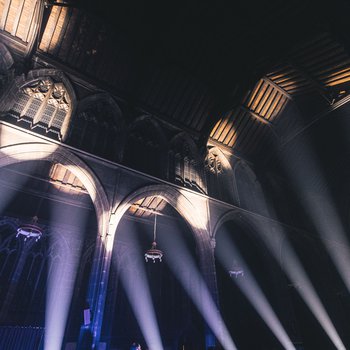 Interior of church with light projections beaming upwards.