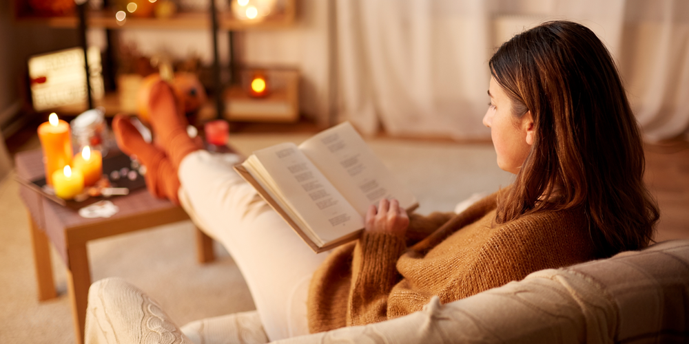 Someone sat reading with a candle lit