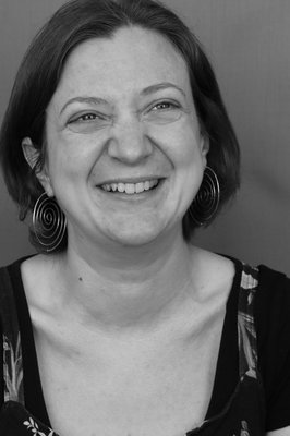 A black and white photo of Leanne Moden, smiling