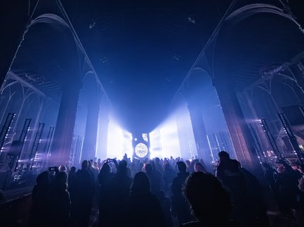 Crowds in a dark church with blue lighting