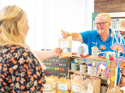 Stallholder smiling talking to a customer