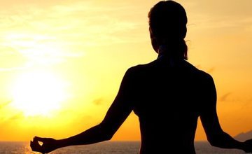 silhouette of lady meditating