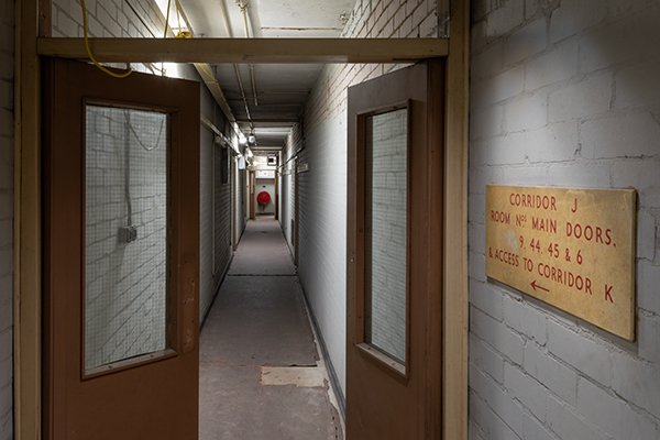 Bunker Corridor grey walls looking through open doors