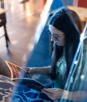 A mirror image of a girl reading