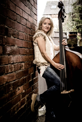 Nicola Farnon standing with her large acoustic bass
