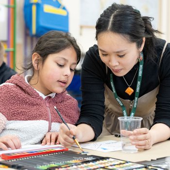 Edwina Kung helping a student with their art map