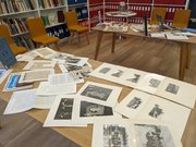 old local history photos and text spread on a table