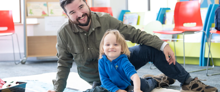 Parent and child playing with lego in the library