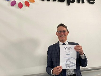 Peter Gaw smiles as Inspire are presented with accreditation for achieving Investors in Diversity.