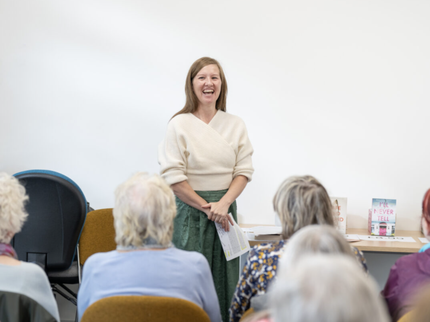 Author Phillippa East talking to a crowd at an author event