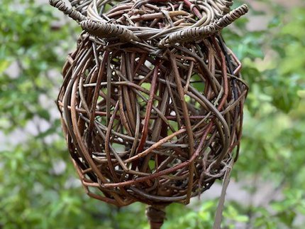 A woven willow poppy seed head